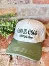 Beige and green cap with 'God is Good, All the time' text on a rustic background