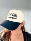 Person wearing a cap with 'Just a Girl Loves Jesus' text against a neutral background